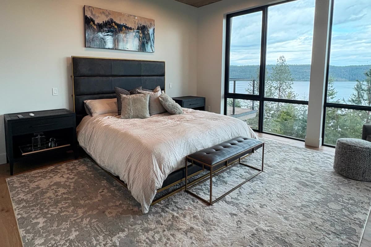 Finished bedroom with lake view in a custom home